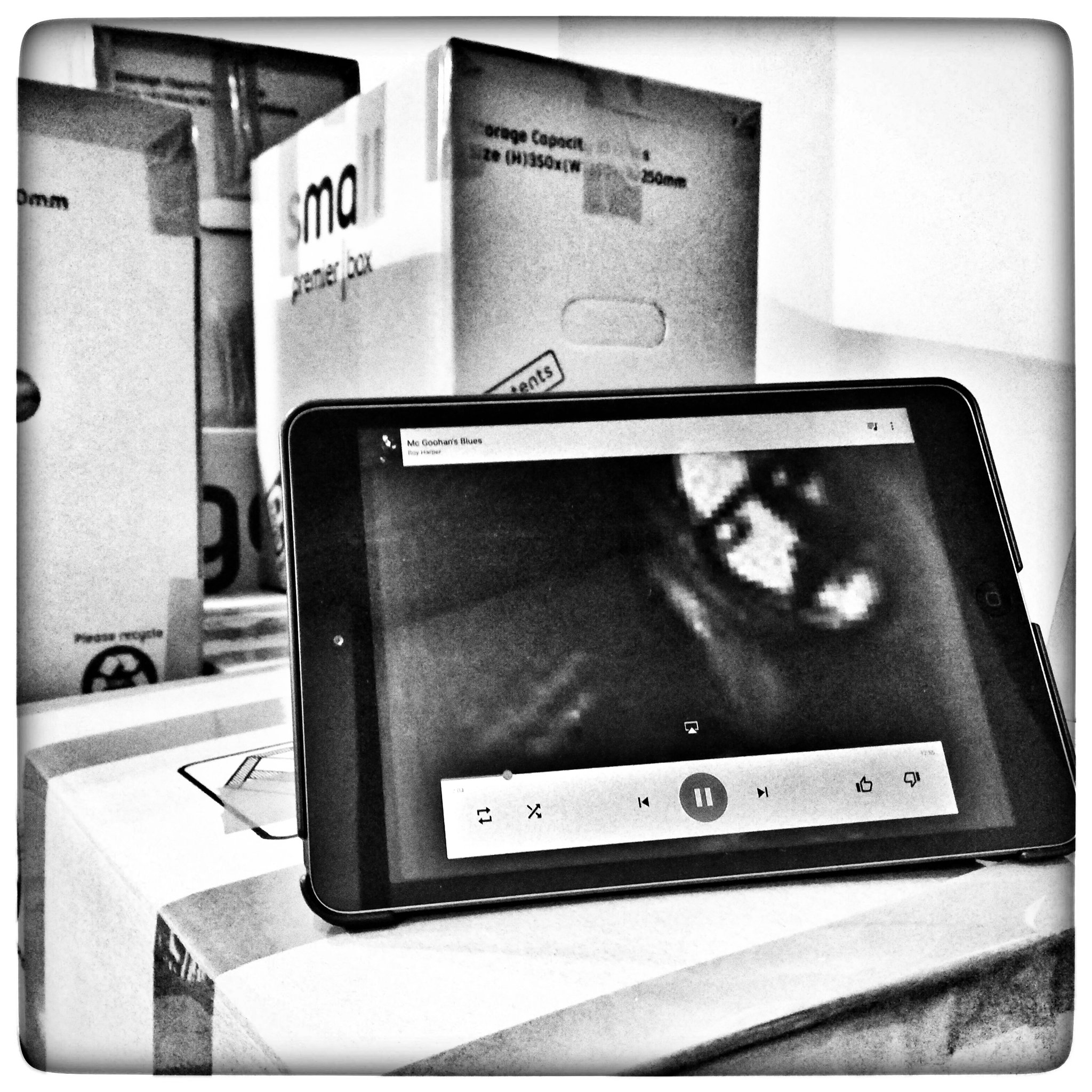 The prisoner is taking his shoes off to walk in the rain.